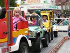 Children enjoying fairground rides in the town centre